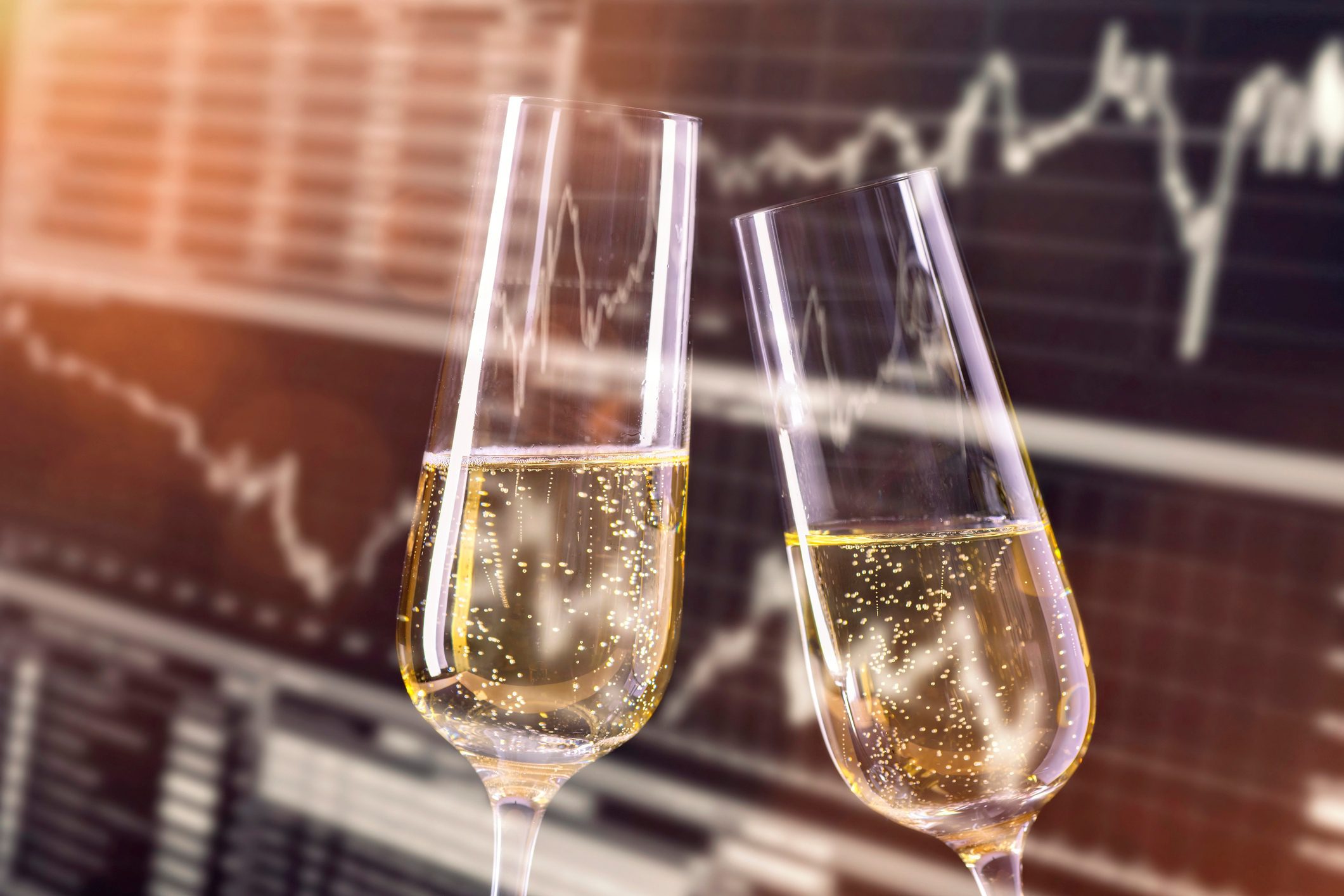 Champagne glasses with stock market background